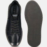 Black leather comfort sneakers by bugatti, featuring patterned laces and a textured sole.