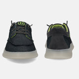 Black comfort sneakers by bugatti with textured upper, neon green accents, and translucent soles.