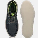 Black comfort sneakers by bugatti, showing a textured upper, green trim, and patterned off-white sole.