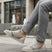 Lifestyle view of bugatti Fiero grey sneakers featuring a breathable textile upper with orange and gray accents.
