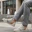 Lifestyle view of bugatti Fiero grey sneakers featuring a breathable textile upper with orange and gray accents.
