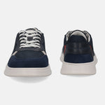 Dark blue sneakers by bugatti with white laces, a suede toe cap, and a contrasting white sole.