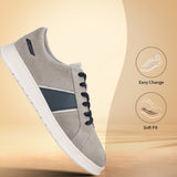 Grey premium leather sneakers by bugatti with navy blue accents, white soles, and black laces.