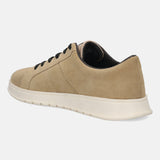 Beige leather comfort sneakers by bugatti with black laces and a textured toe.