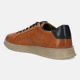 Cognac leather sneaker by bugatti with black heel detail and tan sole, shown in a rear angle view.