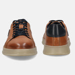 Cognac leather sneakers by bugatti with black laces and heel counter, set on a tan rubber sole.