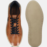 Cognac premium leather comfort sneakers by bugatti, displaying the sole with a textured pattern.