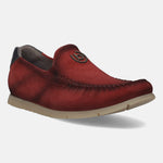 Red leather slip-on shoe by bugatti, featuring moccasin stitching and a metal logo detail.