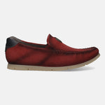 Red leather slip-on shoe by Bugatti, with a perforated texture and a tan sole, shown in a side view.