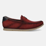 Red leather slip-on shoe by Bugatti, with a perforated texture and a tan sole, shown in a side view.