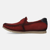 Red leather slip-on shoe by bugatti, featuring moccasin stitching and a dark leather heel accent.