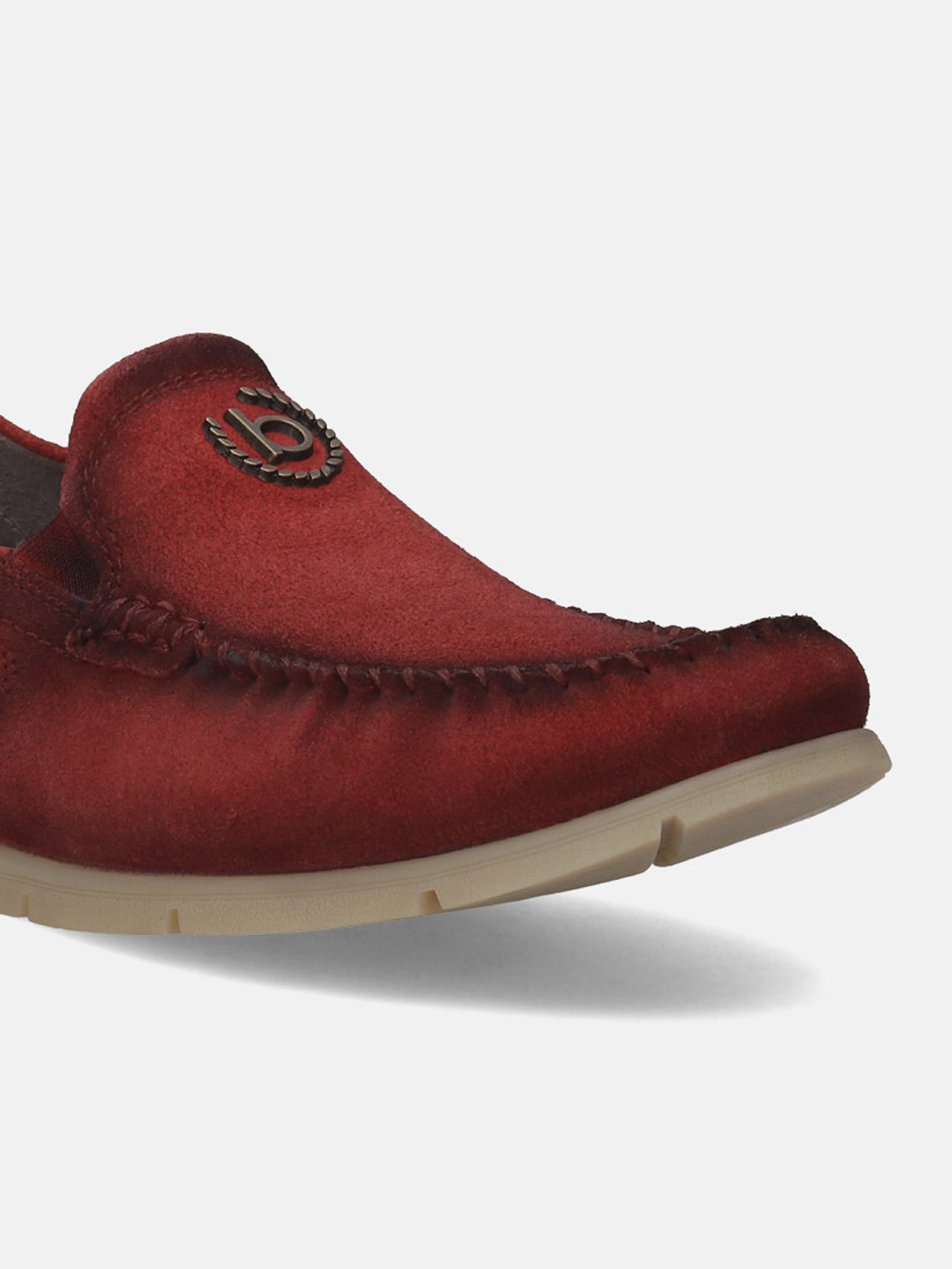 Red leather slip-on shoe by bugatti, featuring decorative stitching and a branded metal emblem.