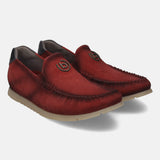Red leather comfort slip-ons by bugatti with dark stitching and metallic logo detail.