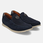 Dark blue leather slip-on shoes by bugatti, featuring a silver-toned logo emblem and contrast stitching.