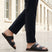 bugatti Cobie black leather sandals with adjustable buckle straps and red stripe on the sole.
