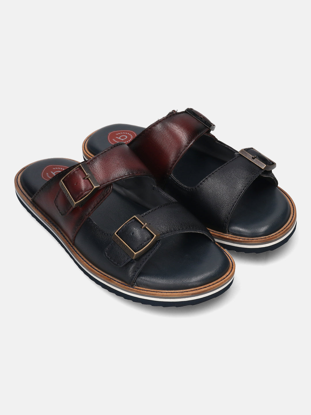 A blue Men's bugatti Mules featuring a round toe plain toe, zero heels heel. Made from premium genuine leather with a durable eva outsole, this slip-on design offers both style and comfort.