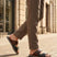 bugatti Cobie dark blue leather sandals with two straps, worn with brown trousers.