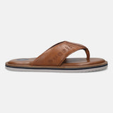 Cognac leather thong sandal by Bugatti with the brand name embossed on the strap and a striped midsole.