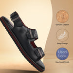 bugatti Cobie black leather sandal with buckle straps and a red-trimmed sole.
