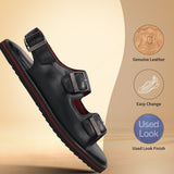 bugatti Cobie black leather sandal with buckle straps and a red-trimmed sole.
