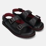Pair of black bugatti leather sandals with buckle straps and red cushioned insoles.
