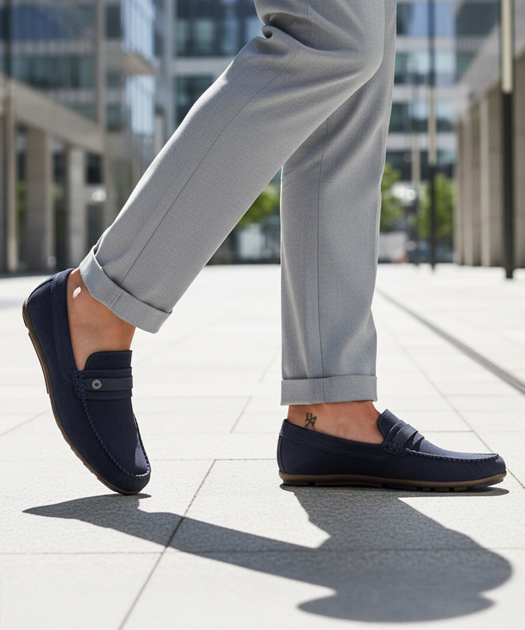 bugatti Corrado dark blue casual slip-on shoe, premium leather, being worn with gray dress pants.
