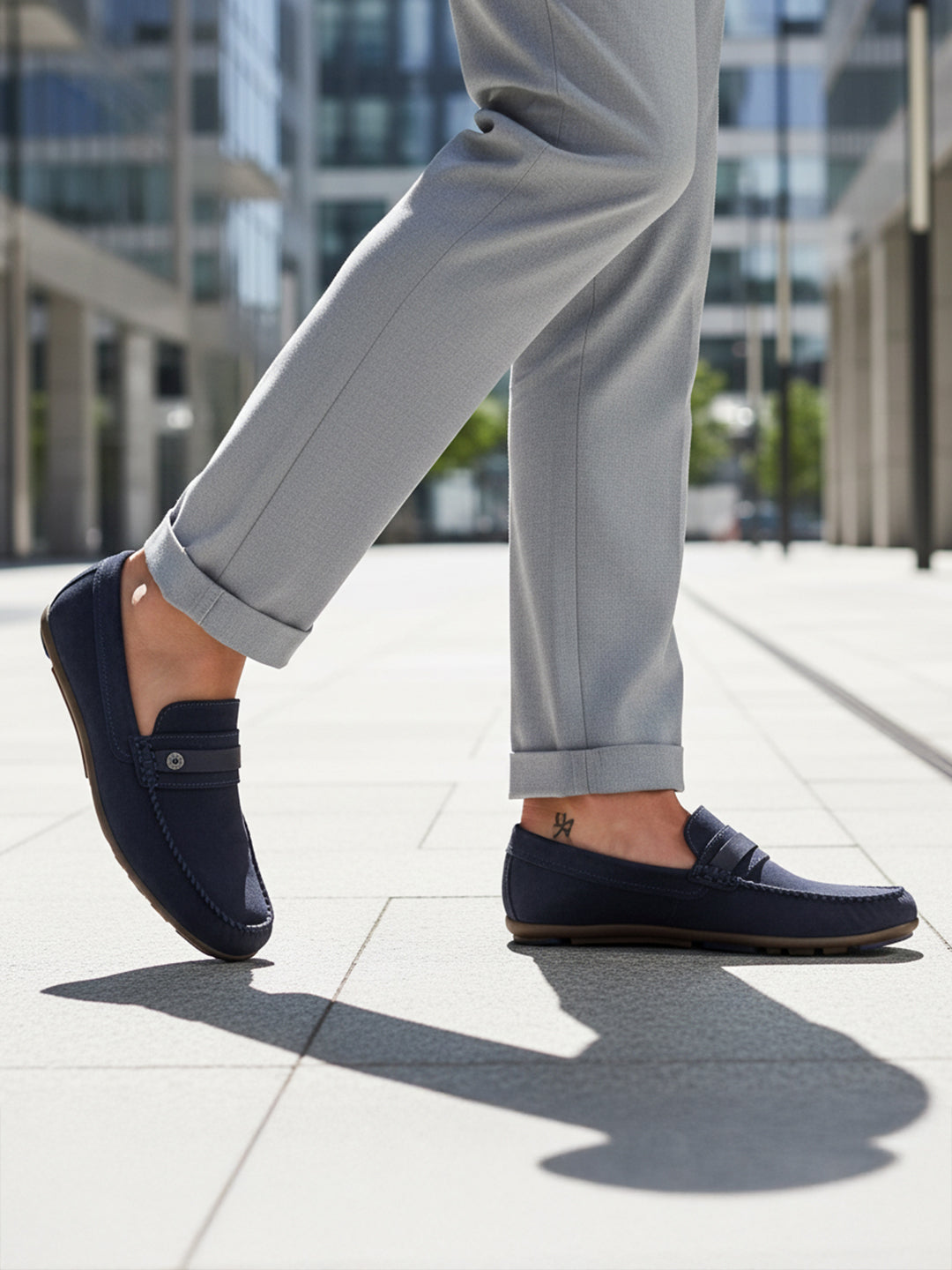 bugatti Corrado dark blue casual slip-on shoe, premium leather, being worn with gray dress pants.
