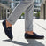 bugatti Corrado dark blue casual slip-on shoe, premium leather, being worn with gray dress pants.
