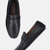 Dark blue leather slip-on shoes by bugatti with a silver-toned decorative strap.