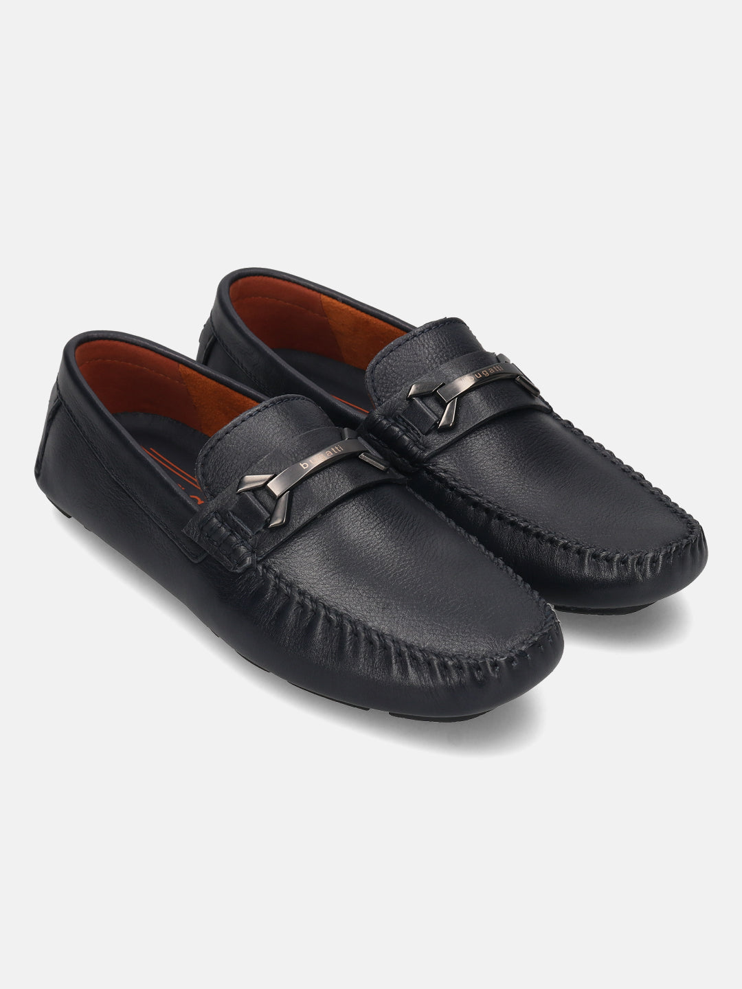 Dark blue leather slip-on shoes by bugatti with a metallic strap and tonal stitching.