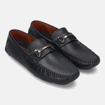 Dark blue leather slip-on shoes by bugatti with a metallic strap and tonal stitching.