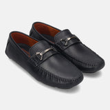 Dark blue leather slip-on shoes by bugatti with a metallic strap and tonal stitching.