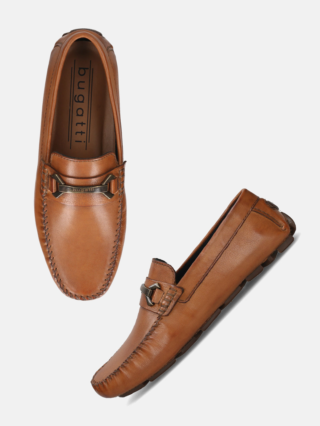 Cognac leather slip-on loafer by Bugatti, featuring metal accent and hand-stitched detailing.