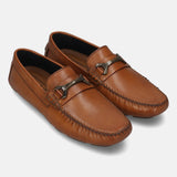 Cognac leather slip-on shoes by Bugatti, featuring decorative metal accents on the vamp and hand-stitched detailing.
