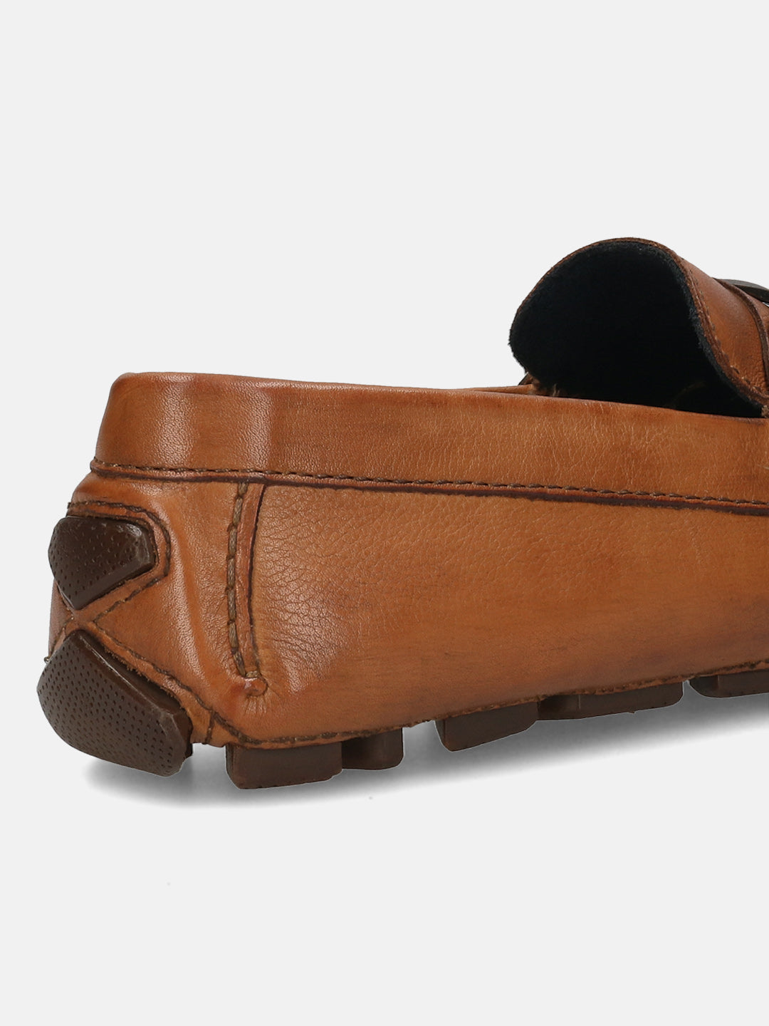 Cognac leather slip-on shoe by bugatti, showing the texture and dark brown rubber heel.