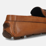 Cognac leather slip-on shoe by bugatti, showing the texture and dark brown rubber heel.