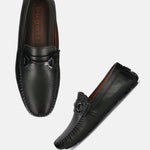 Dark green leather slip-on shoes by Bugatti with a decorative metal detail.