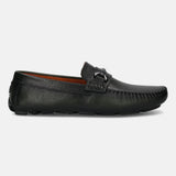 Dark green leather slip-on shoe by bugatti, featuring a metal accent and moccasin stitching detail.