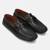 Dark green leather slip-on shoes by bugatti with a stitched toe and metallic accent piece.