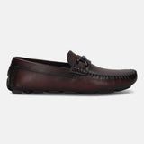 Bordeaux leather slip-on casual shoe by bugatti, featuring a metal accent piece on the upper and a textured outsole.
