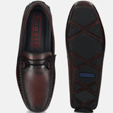 Bordeaux leather slip-on shoes by bugatti with stitched detailing and rubber soles, shown from above and below.