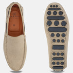 Sand-colored leather slip-on casual shoes by bugatti, featuring textured uppers and patterned outsoles.