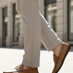 bugatti Linex yellow leather slip-on shoes with moccasin style, worn with light neutral dress pants.
