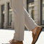 bugatti Linex yellow leather slip-on shoes with moccasin style, worn with light neutral dress pants.
