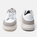 White leather sneakers by bugatti with gray suede accents and a contrasting platform sole.