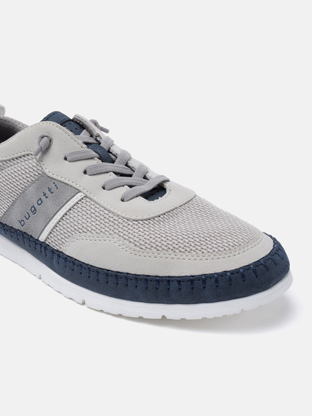 Sand-colored low-top sneakers by Bugatti, with gray suede details and navy blue trim around the toe.