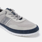 Sand-colored low-top sneakers by Bugatti, with gray suede details and navy blue trim around the toe.