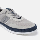 Sand-colored low-top sneakers by Bugatti, with gray suede details and navy blue trim around the toe.