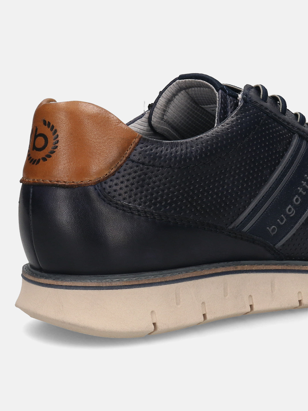 Dark blue leather comfort sneakers by bugatti with a perforated texture and tan heel.