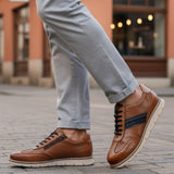 Lifestyle close-up of bugatti Sprinter cognac leather sneakers with black laces and zipper detail.